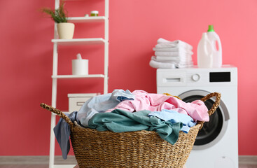 Wicker basket with laundry in bathroom, closeup