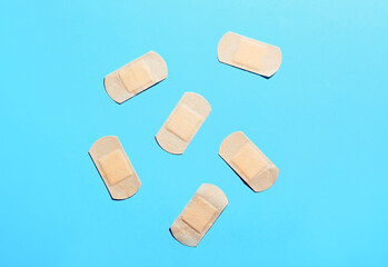 Elastic medical plasters on color background