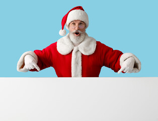 Santa Claus with blank poster showing something on color background