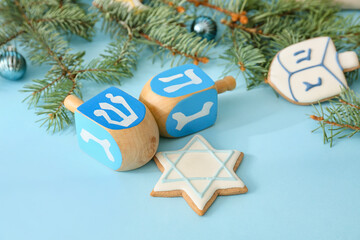 Symbols of Hanukkah and Christmas decor on color background