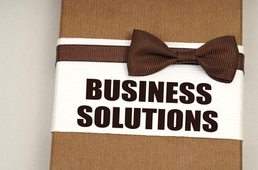 On the packing box with a bow-tie the inscription - Business Solutions