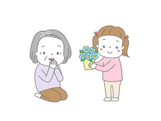 おばあちゃんに鉢花をプレゼントしている女の子