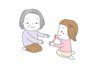 あやとりで一緒に遊ぶおばあちゃんと女の子