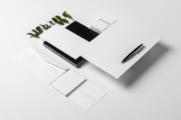 Branding and stationery mockup for branding projects, with elements of foliage on granite, paper clips, pen,A4 envelope, letter envelope, business card, notepad, notebook and letterhead.