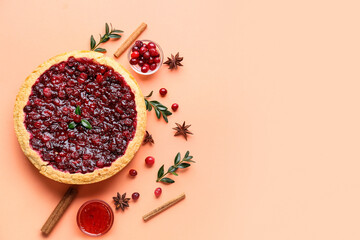 Tasty lingonberry pie with spices and jam on color background
