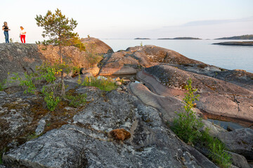 People inspect the nature of the skerries on Lake Ladoga in the Republic of Karelia in Russia