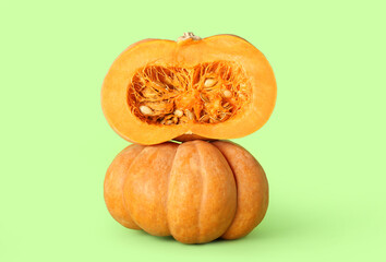 Ripe tasty pumpkins on color background