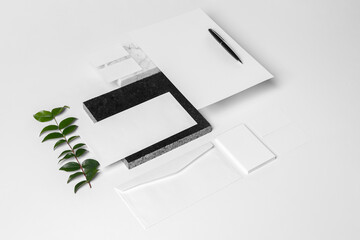 Branding and stationery mockup for branding projects, with elements of foliage on granite, paper clips, pen,A4 envelope, letter envelope, business card, notepad, notebook and letterhead.