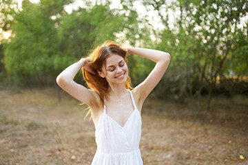 Fototapeta premium cheerful woman gesturing with her hands freedom nature sun