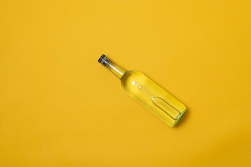 top view of bottle of tequila, mezcal or vodka on yellow background - obrazy, fototapety, plakaty
