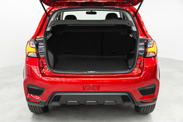 Clean, open empty trunk in the red car SUV. - obrazy, fototapety, plakaty