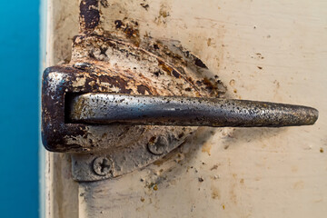 Rusty iron handle of an old refrigeration unit.