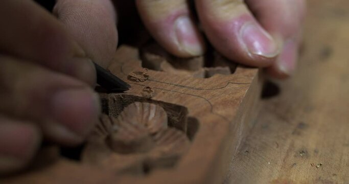 Close up of Chinese style carpenter carving on wood making traditional asian style furniture