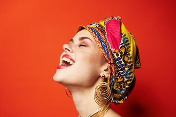 beautiful woman ethnicity multicolored headscarf makeup glamor red background