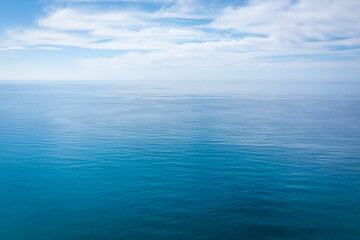 Closeup surface of calm ocean blue sea water with day light and clouds. Abstract Background Texture. - 467075585