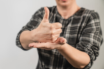 Deaf woman show her hand for Help or aid as sign language. Deaf body language concept 