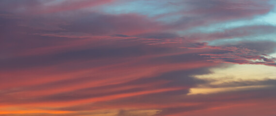 Naklejka na ściany i meble Background photos of an expressive sky with colored clouds