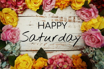 Happy Saturday text and Flowers Colorful Border Frame on wooden background