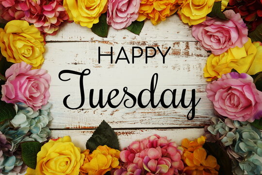 Happy Tuesday text and Flowers Colorful Border Frame on wooden background