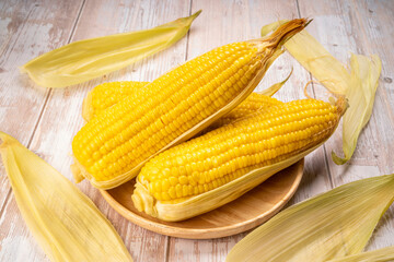 Boiled sweet corn ready to serve  in wooden background, Corn on a wooden table background.