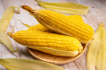Boiled sweet corn ready to serve  in wooden background, Corn on a wooden table background.