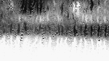 Background of natural condensation of water on transparent glass with high air humidity, large drops dripping