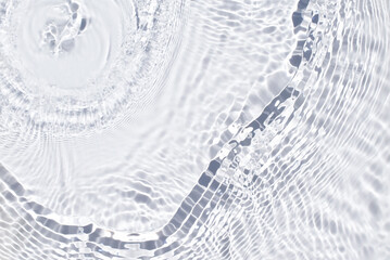 Water spills on a light blue background. Natural sunlight and shade. Beautiful bursts and glare. Summer mood. Minimal style.