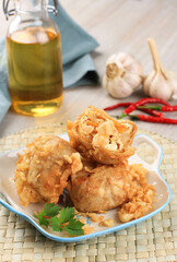 Tahu Isi or Indonesian Fried Stuffed Tofu, Traditional Snack Made of Crispy Tofu Stuffed with Stir Fry Vegetable, Served with Chili or Chili Sauce.