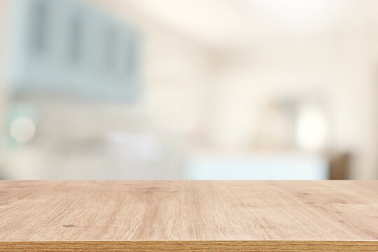 empty table board and defocused modern kitchen background. product display concept