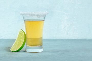Tequila shot with lime, a Mexican alcohol drink with a salted rim, with a place for text