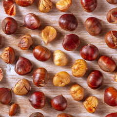 Cooked chestnuts, square shot from the top on a rustic wooden background. Healthy vegan autumn food