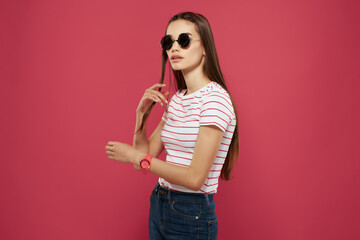 pretty woman in striped t-shirt sunglasses pink background glamor