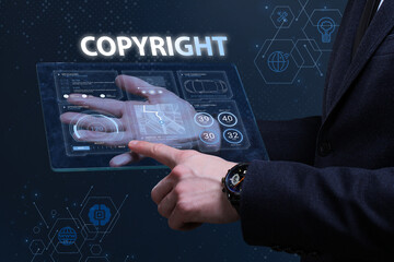 Business, Technology, Internet and network concept. Financial Graph. Stock Market chart. Young businessman working on a virtual screen of the future and sees the inscription: Copyright