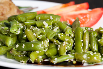 baked asparagus beans with sesame seeds and meat cutlet