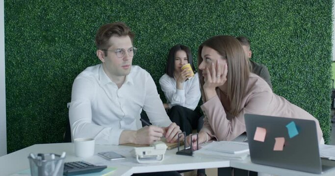 Harassment at work place. woman touches man at workplace. in modern office. sexy caucasian woman and man work in office. corporate ethics. businessman and assistant. secretary with boss at workplace