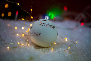 Christmas balls in the snow with lights