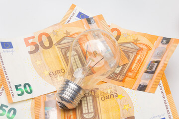 Banknotes and light bulbs on top of the money