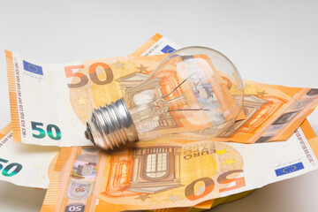 Banknotes and light bulbs on top of the money