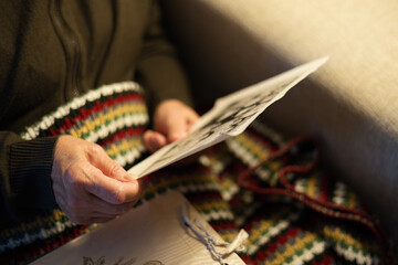 Old woman looking at vintage family photos