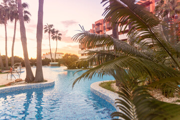 Fototapeta premium Photography of a residential area during the sunset with palms and pool