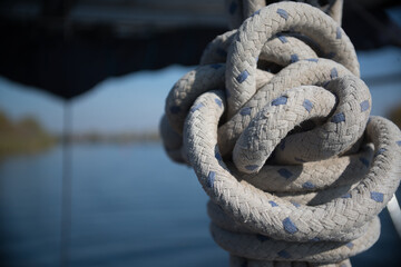 Yacht rigging knot on a blurred water area background
