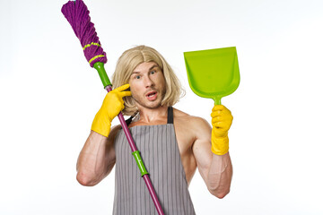 a man in aprons in a woman's wig with a mop cleaning