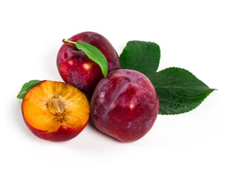 Ripe, juicy plums with green leaves on white background. Red plums in natural condition.