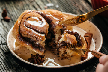 Cinnamon rolls or cinnabon on a plate on a wooden table. Food recipe background. Close up
