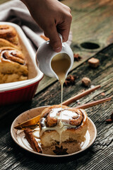 homemade Sinnabon buns with cinnamon and white cream sauce. sweet traditional dessert buns