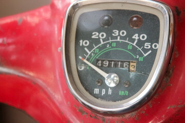 Old motor bike meter close-up shot.Scooter scratched speedometer closeup view.Speedometer dial on a...