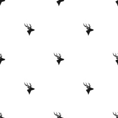 seamless winter pattern with black deer heads with antlers.