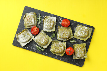 Concept of cooking ravioli on yellow background
