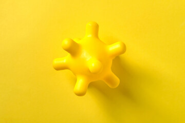 Yellow baby massager on yellow background, top view