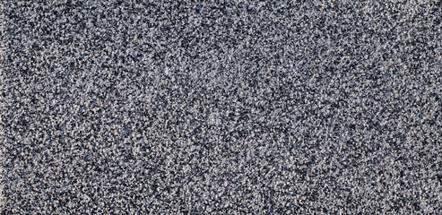 slab covered with small stones of quartz, white and black. background texture.